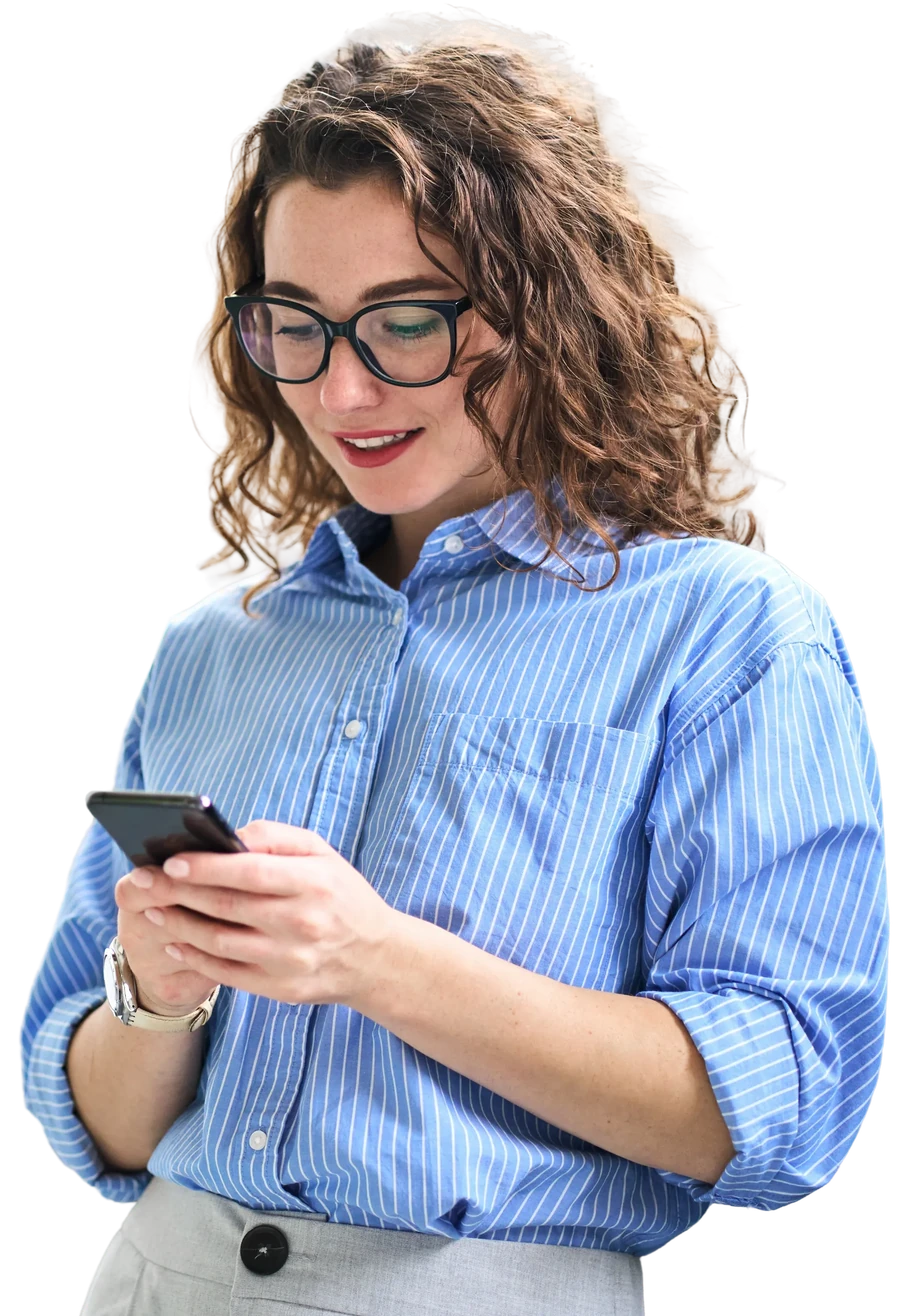 Smiling woman in glasses and a striped shirt typing on her phone